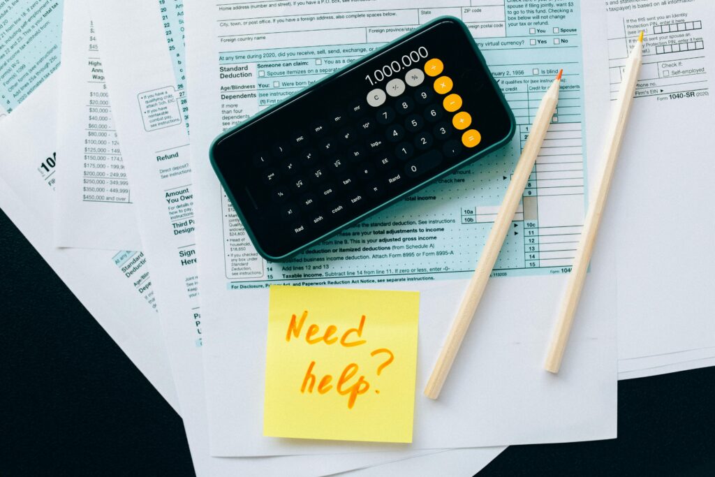 Calculator and tax forms with a Need help? sticky note